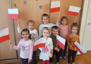 dzieci z własnoręcznie wykonanymi flagami