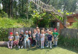 dzieci z grupy VII stoją przed domkiem skrzata