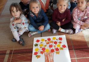 dzieci z grupy VII ze swoją pracą jesiennego drzewa