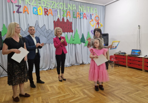 nauczycielka wraz z wychowanką z PP Nr 3 "Wesoła Trójeczka" w Zduńskiej Woli odbierają nagrody z rąk Przemysława Holewskiego - Zastępcy Biura Edukacji, Sportu i Spraw Społecznych oraz Agnieszki Sapiejki - dyrektora Publicznego Przedszkola Nr 10 "Pod Słoneczkiem" w Zduńskiej Woli i Justyny Kunert - zastępcy dyrektora Publicznego Przedszkola Nr 10 "Pod Słoneczkiem"w Zduńskiej Woli