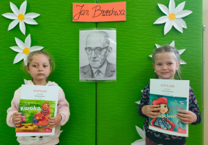 dziewczynki z nagrodami na tle portretu Jana Brzechwy