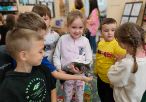 dzieci trzymają kotka