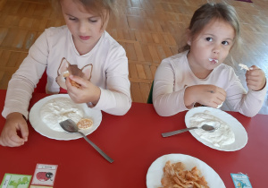 dziewczynki jedzą podwieczorek - serek z chipsami jabłkowymi