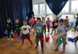 przedszkolaki tańczą z kolorowymi pomponami