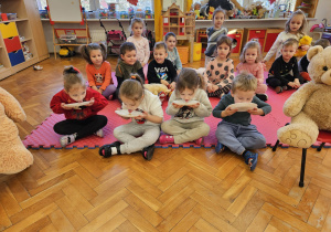 przedszkolaki udają, że są niedźwiadkami i liżą z talerzyków miód