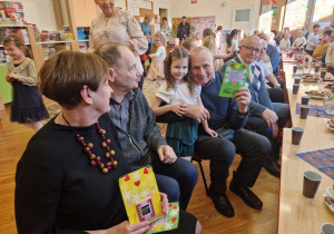 dziadek tuli wnuczkę po otrzymaniu laurki