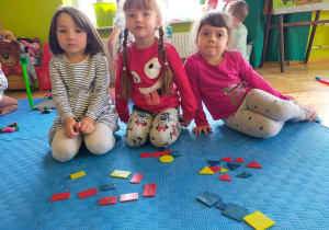 dziewczynki z klockami w kształcie figur geometrycznych