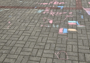 przedszkolaki rysują kredą na trasie przedszkolnym