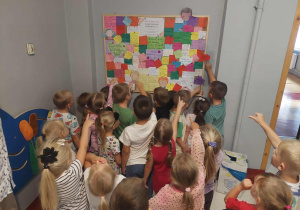 przedszkolaki przed tablicą zdobrymi wiadomościami od rodziców szukają wiadomości dla siebie