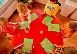 dzieci podczas wykonywania prac plastycznych - dyniowego ludzika