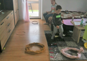 chłopiec pokoju pokonuje tor przeszkód zrobiony z zawiązanych szalików i ułożonych w kształcie kół