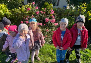 ogródki działkowe - dzieci obok krzewu róży