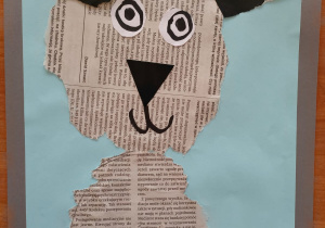 praca plastyczna, wycinanka wykonana z gazety biało czarnej - portret psa z czarnymi uszami