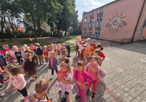 dzieci na tarasie pokazują swoje kolorowe liście