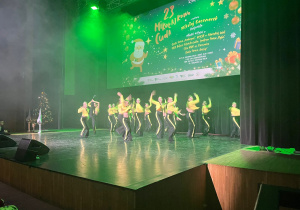 zespól taneczny w żółto - czarnych strojach na scenie