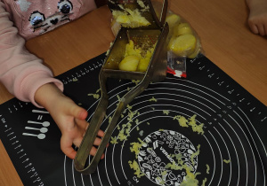 dzieci wkładają ziemniaki do kwiećki