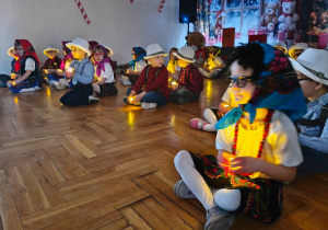 dzieci siedzą z laterenkami