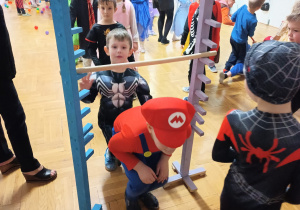 dzieci przechodzą pod poprzeczką