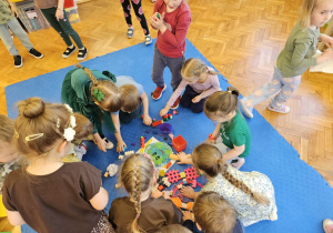 dzieci uczą się segregacji śmieci - dzieci oczyszczają Ziemię ze śmieci i odnoszą do właściwych pojemników